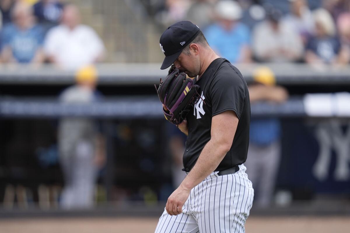 New York Yankees starting pitcher Carlos Rodon walks off the field after being taken out of the game in the fourth inning of a spring training baseball game against the Tampa Bay Rays Wednesday, March 6, 2024, in Tampa, Fla. (AP Photo/Charlie Neibergall)