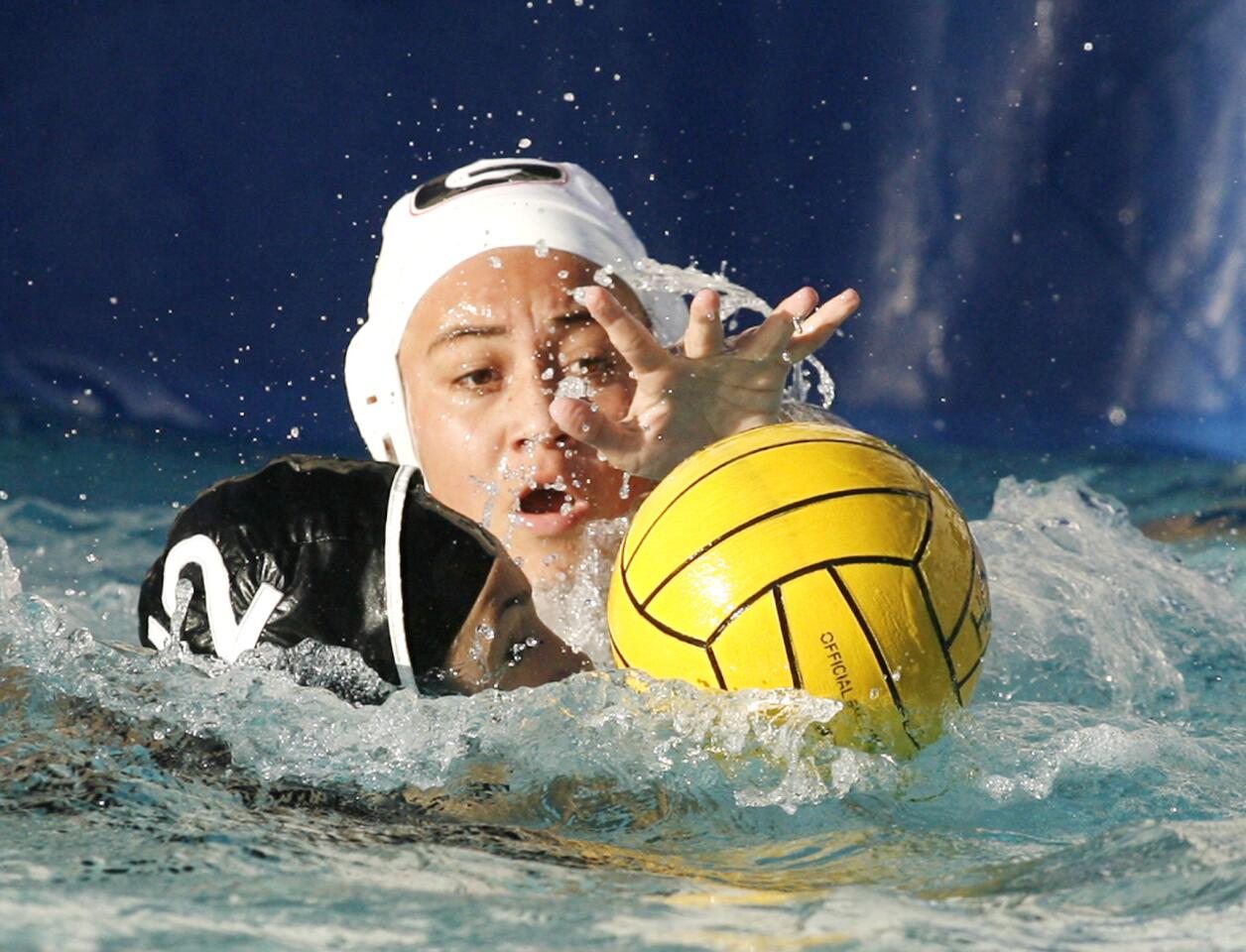 Glendale's Maddie Corpuz reaches to the ball in front of the Hoover goal against Hoover's Maggie Amirian in the second quarter in a Pacific League girls water polo match at Hoover High School in Glendale on Thursday, January 10, 2013.