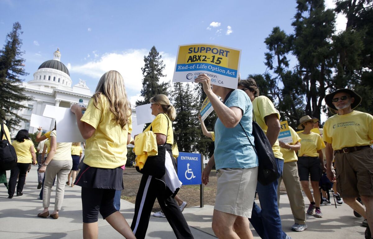 Marchers outside the Capitol in Sacramento call on Gov. Jerry Brown to sign a bill allowing the terminally ill to end their own life, on Sept. 24, 2015.