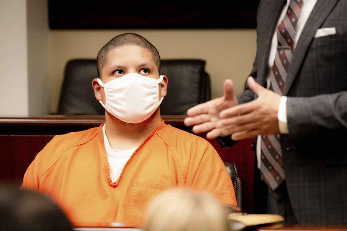 Joseph Jimenez looks at his attorney, Charles Kenyon, during his arraignment at the Riverside Hall of Justice on Thursday.