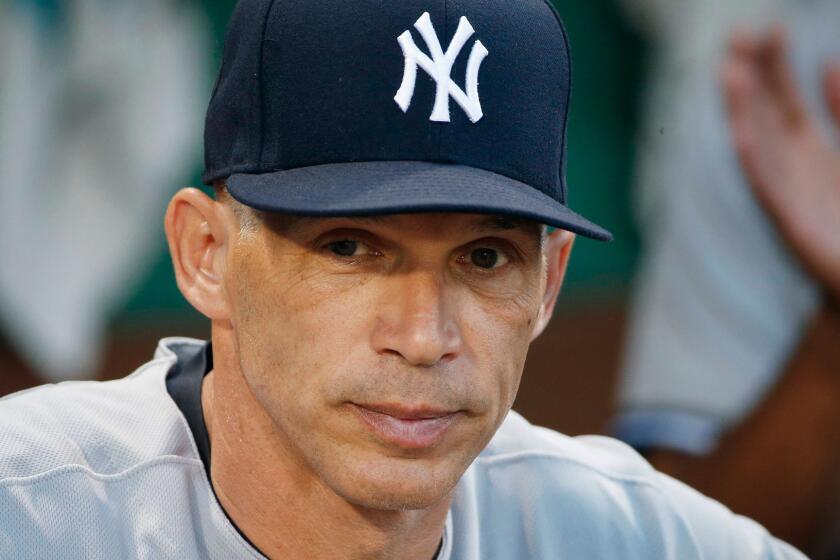 FILE - In this July 16, 2017, file photo, New York Yankees manager Joe Girardi stands in the dug out before the second game of a baseball doubleheader against the Boston Red Sox, in Boston. The New York Yankees announced Thursday, Oct. 26, 2017, that Girardi will not return to the team in the 2018 season. The announcement was made by Yankees Senior Vice President and General Manager Brian Cashman. (AP Photo/Michael Dwyer, File)