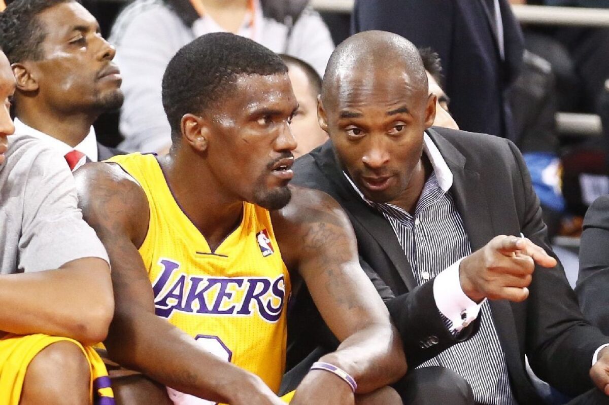 Kobe Bryant talks to Darius Johnson-Odom during an exhibition game between the Lakers and Golden State in Beijing on Tuesday.