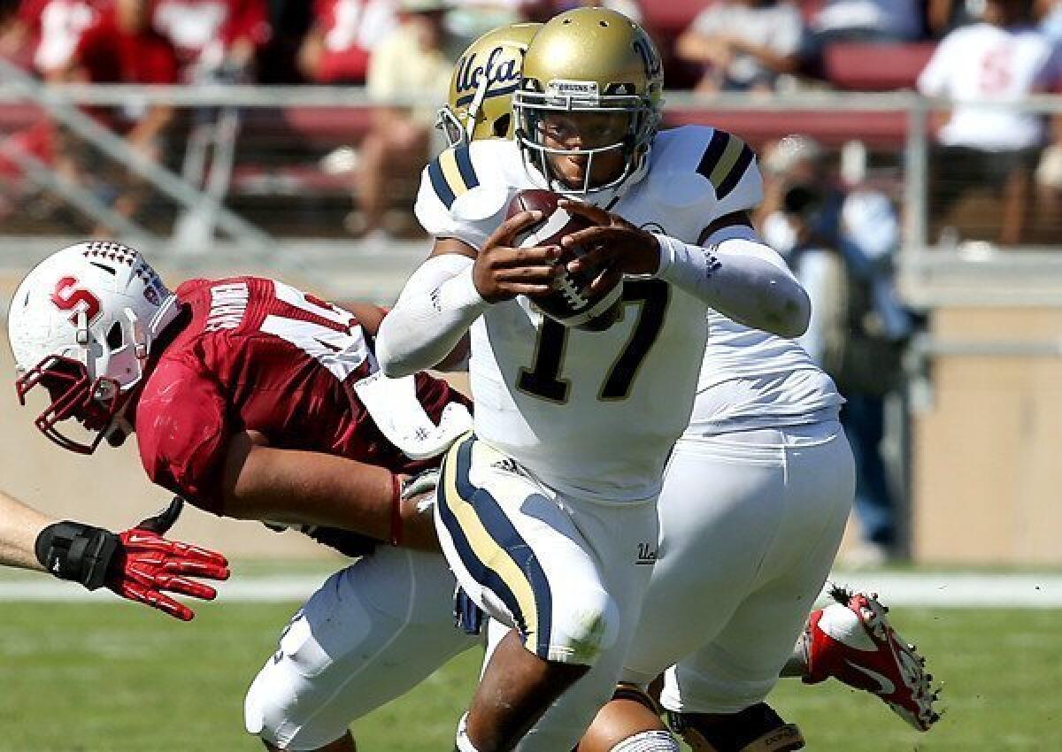UCLA quarterback Brett Hundley looks for room to run on a draw against Stanford in the second quarter Saturday at Stanford Stadium.