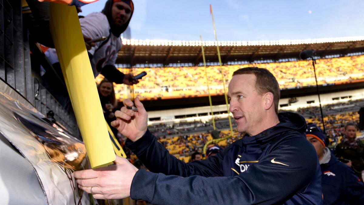 Broncos quarterback Peyton Manning signs autographs for fans before a game in Pittsburgh on Dec. 20, when he was sidelined with a sore foot.