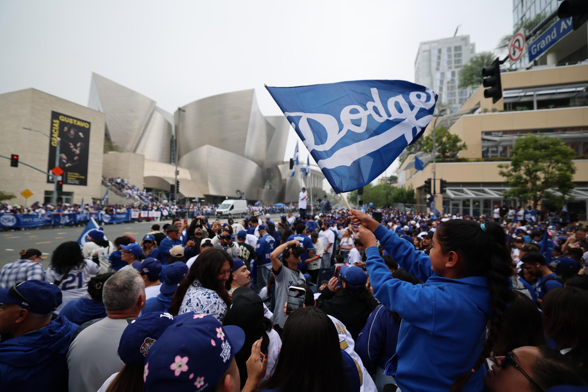 Pictures: World Sequence Champion Dodgers parade by Downtown LA 3 Mia Nava, 9, waves a flag. "She's skipping school today and her teachers know her passion." Said her mom, Jennie Nava.