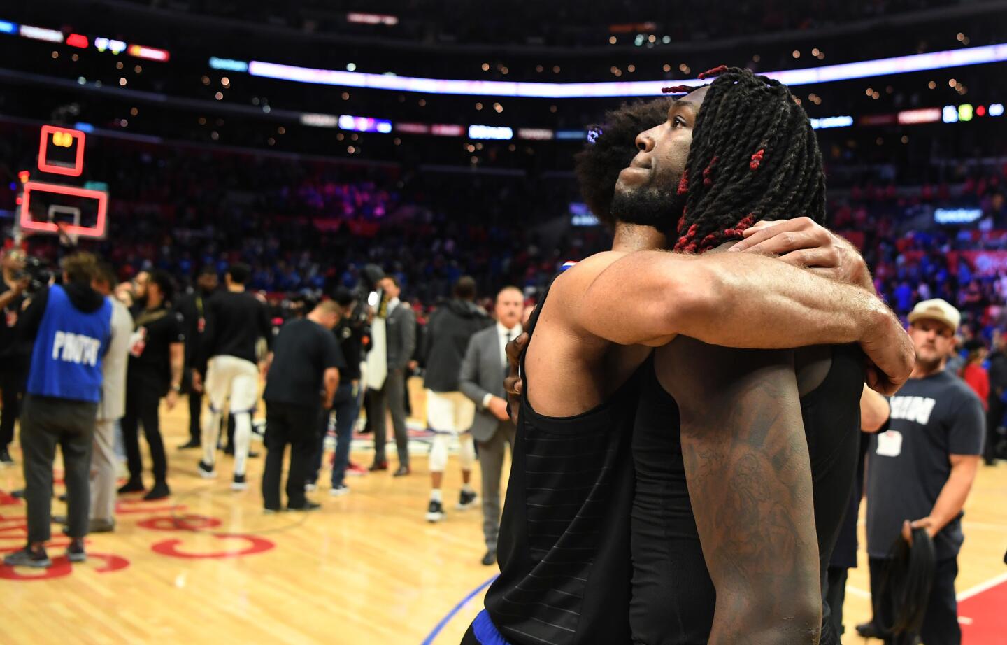 Clippers' Montrezl Harrell, right, is hugged by teamate Jerome Robinson after they were eliminated by Warriors in Game 6 of the NBA playoffs at Staples Center.