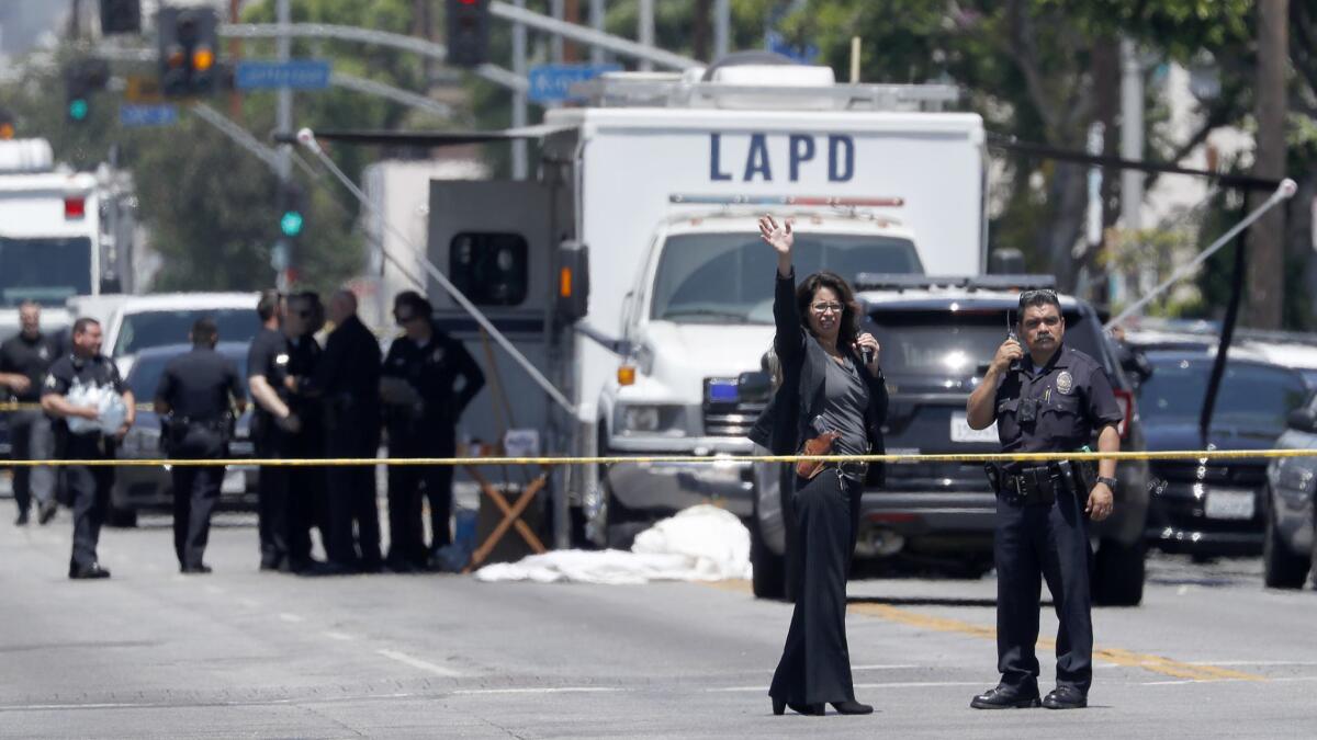 Police set up a command post near the intersection of Central Ave. and 42nd Street in South Los Angeles, the scene of an officer-involved shooting.