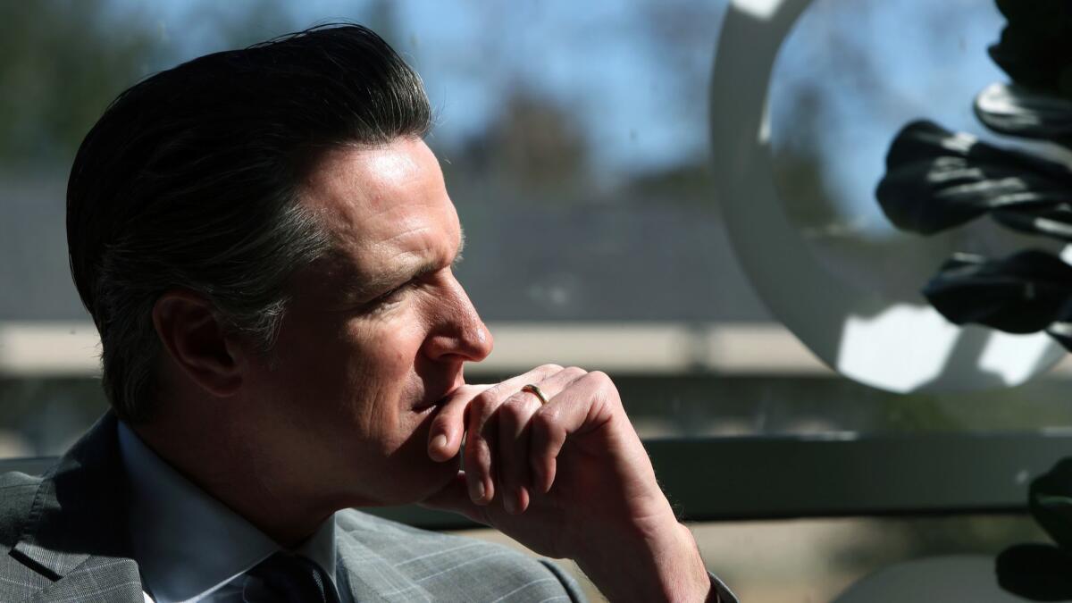 Gov. Gavin Newsom listens to community members of Century Villages at Cabrillo, an affordable housing development, last month in Long Beach.