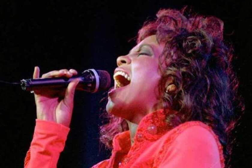 Whitney Houston performs in Anaheim in 1994. On Thursday, Los Angeles health officials said that the singer died in an accidental drowning. Cocaine and heart disease were also factors in her death.