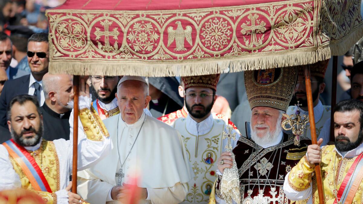 Pope Francis and Catholicos of All Armenians Karekin II, center right, arrive to attend liturgy at a cathedral in Etchmiadzin, Armenia.