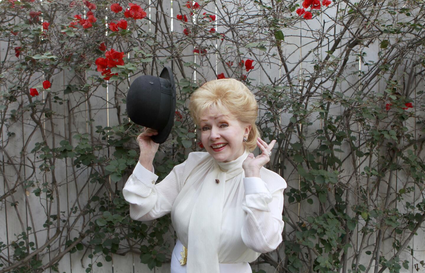 Debbie Reynolds, holding Charlie Chaplin's Hat.