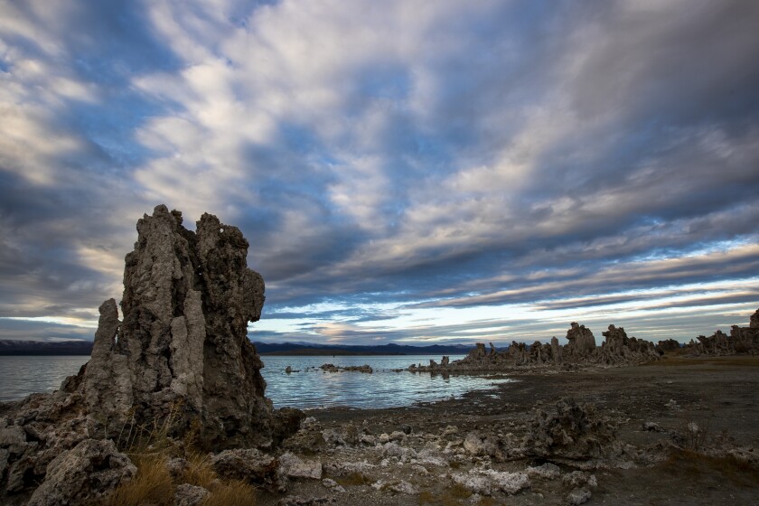 Passing clouds provide a striking backdrop for exposed tufa towers along the shore of Mono Lake
