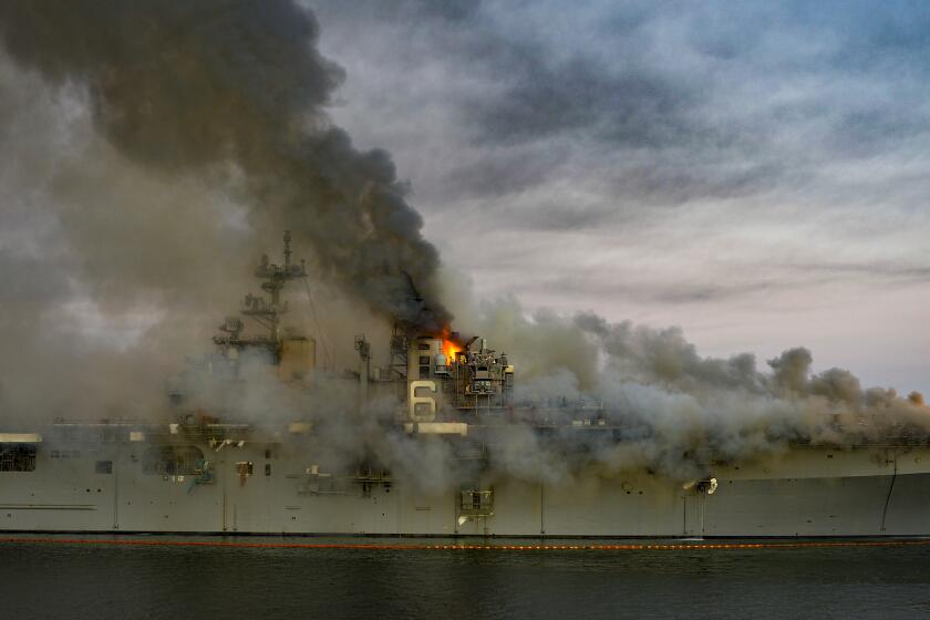 A fire continues to be fought into the evening on board the amphibious assault ship USS Bonhomme Richard 