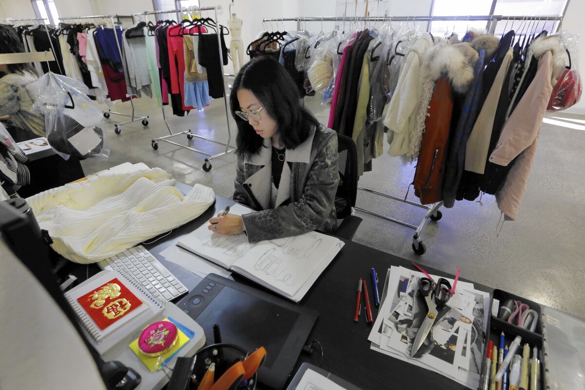 Associate designer Chrystal Lacza works on drawings at her desk at online clothing retailer Tobi in Los Angeles. This is the company's slow period because of Chinese New Year.