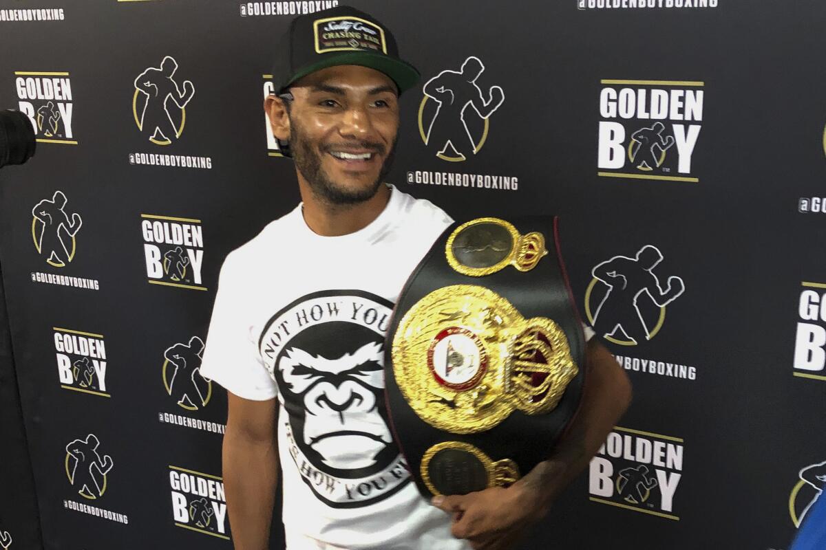 In this Tuesday, June 18, 2019 photo, WBA super featherweight champion Andrew Cancio speaks to reporters at the Westside Boxing Club in Los Angeles. Cancio is a boxing champion who also works for the Southern California Gas Company, and he plans to keep his day job even after his lucrative rematch with Alberto Machado in Indio, Calif.