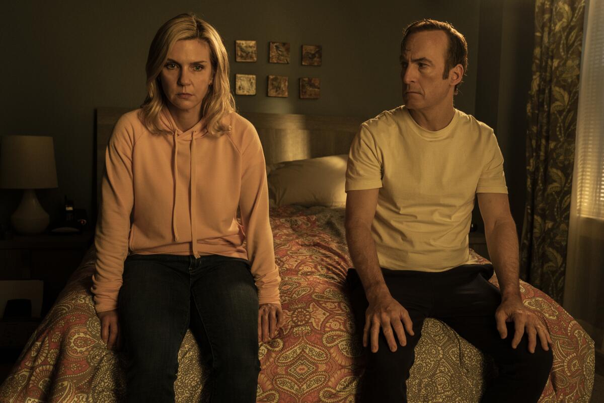 A man and a woman sit on the end of a bed together in a scene from "Better Call Saul."