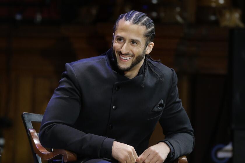 FILE - In this Oct. 11, 2018, file photo, former NFL football quarterback Colin Kaepernick smiles on stage during W.E.B. Du Bois Medal ceremonies at Harvard University, in Cambridge, Mass. Kaepernick plans to audition for NFL teams on Saturday, Nov. 16, 2019, in a private workout arranged by the league to be held in Atlanta. (AP Photo/Steven Senne, File)