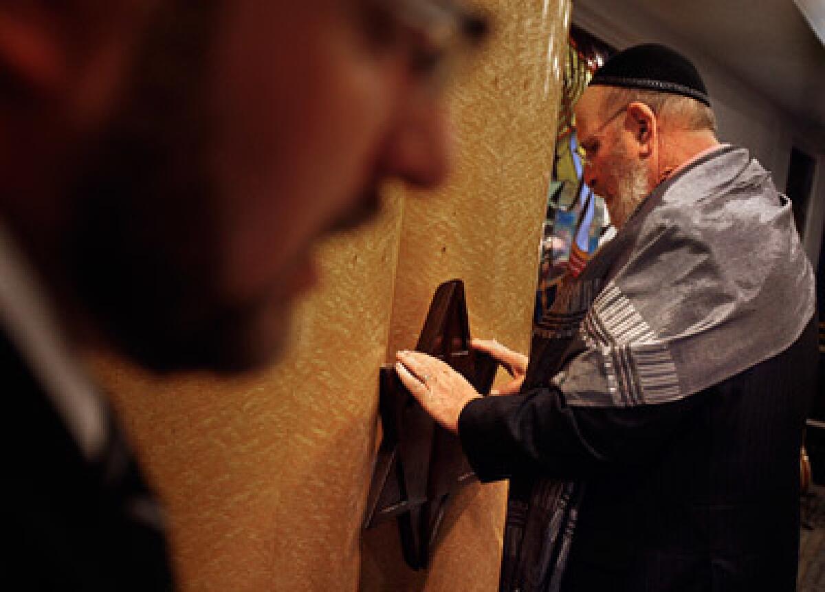 Rabbi Mark Borovitz, right, holds onto the Star of David while focusing himself during a prayer being said during Shabbat services at Beit T'Shuvah, a Jewish residential rehabilitation center that has about 120 residents in treatment on a consistent basis. Audio slide show: Breaking the chains of addiction.