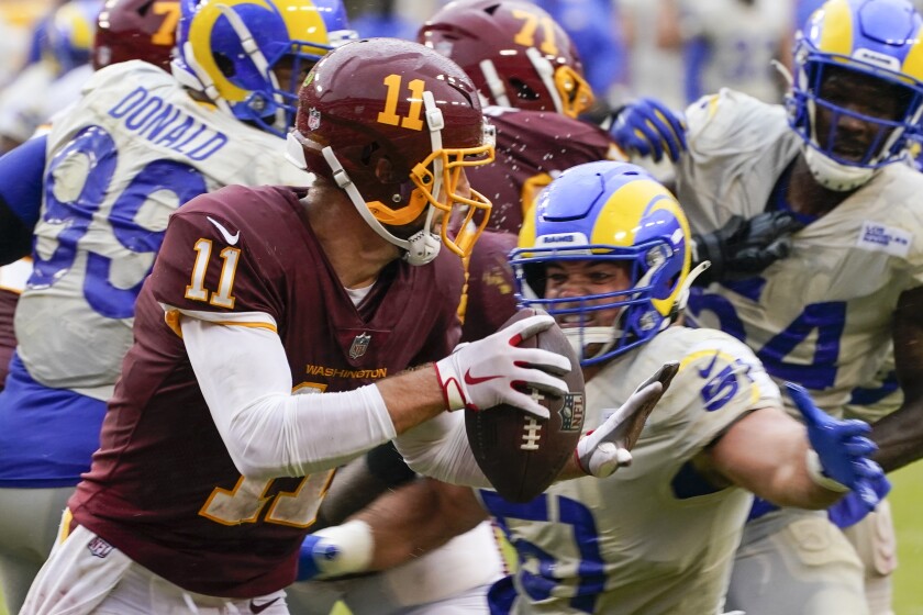 Washington Football Team's Alex Smith was sacked three times by the Rams' Troy Reeder.