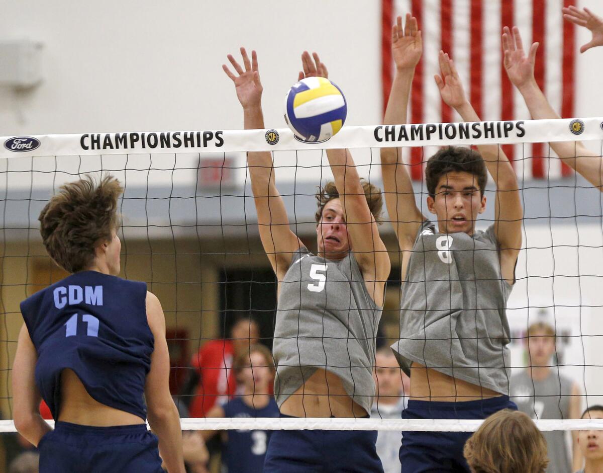 Corona del Mar's Sterling Foley (11) is blocked by Newport Harbor's Riggs Guy (5) with help from Lukas Johnson (8).