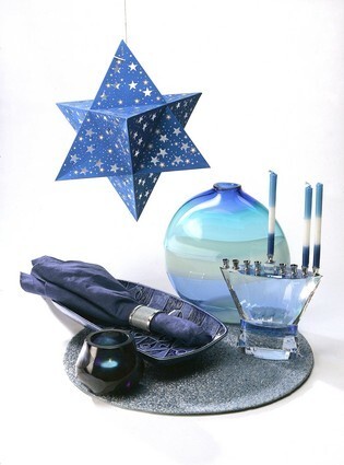 A modern Hanukkah tableau: Large Helsinki dish by Jonathan Adler, $88 from www.moderntribe.com. Linen napkin, $24, shagreen napkin ring, $70, and beaded placemat, $40, from Table Art, 7977 Melrose Ave., (323) 653-8278, www.tartontheweb.com. Blue resin votive on napkin, $19.95, and blue glass vase by Caleb Siemon, from Craft and Folk Art Museum. Faceted menorah from the Mitzvah Store, 9400 W. Pico Blvd., (310) 247-9613. Striped blue menorah candles, $14 for a multicolored set of 45, and Star of David paper lantern, $11, also from www.moderntribe.com.