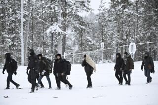 Finnish Border Guards escort migrants arriving at the Raja-Jooseppi international border crossing station between Russia and Finland, in Inari, northern Finland, Saturday, Nov. 25, 2023. The European Union’s border agency says that it will send dozens of officers and equipment as reinforcements to Finland to help police its borders amid suspicion that Russia is behind an influx of migrants arriving to the country. (Emmi Korhonen/Lehtikuva via AP)