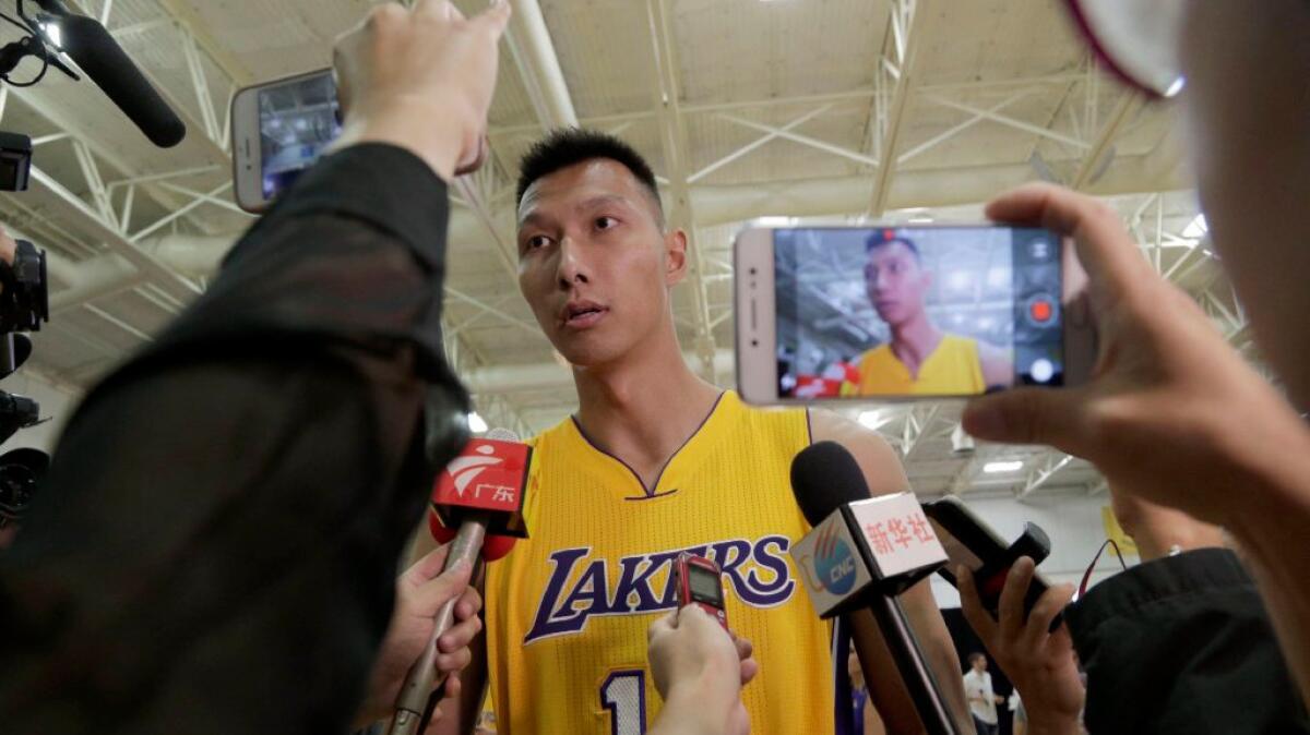 Yi Jianlian speaks to reporters during the Lakers' media day at the team's practice facility in El Segundo on Sept. 26.