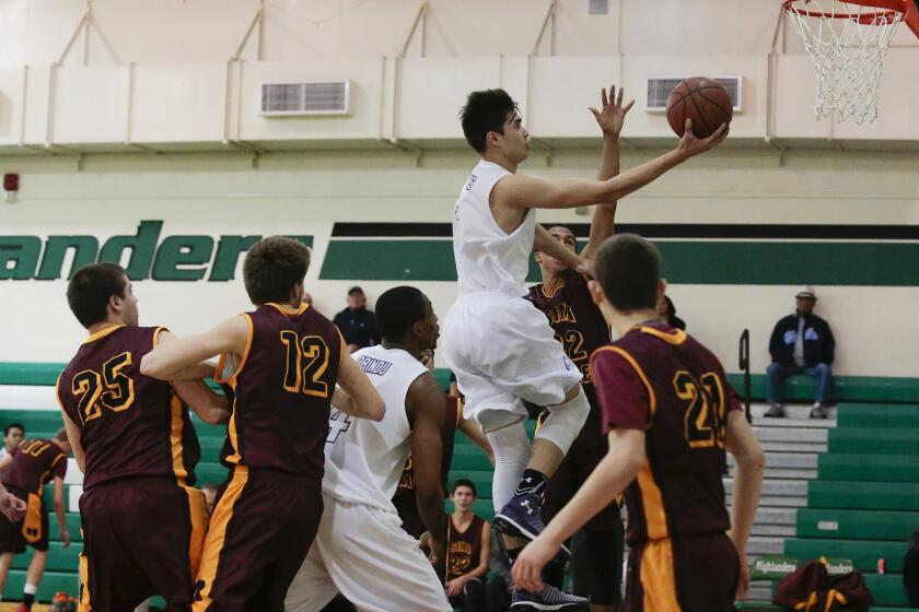 Cathedral's Kobe Paras slices to the basket for a layup against Simi Valley High during a game on Dec. 18.