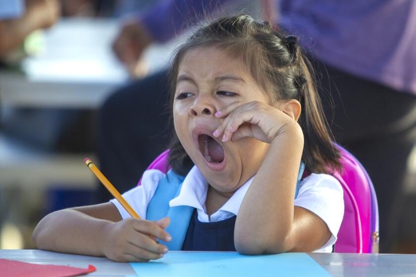 Lucia Reynoso, 5, yawns during the first day of school at the charter school, International School for Science and Culture in Costa Mesa on Tuesday, September 3.