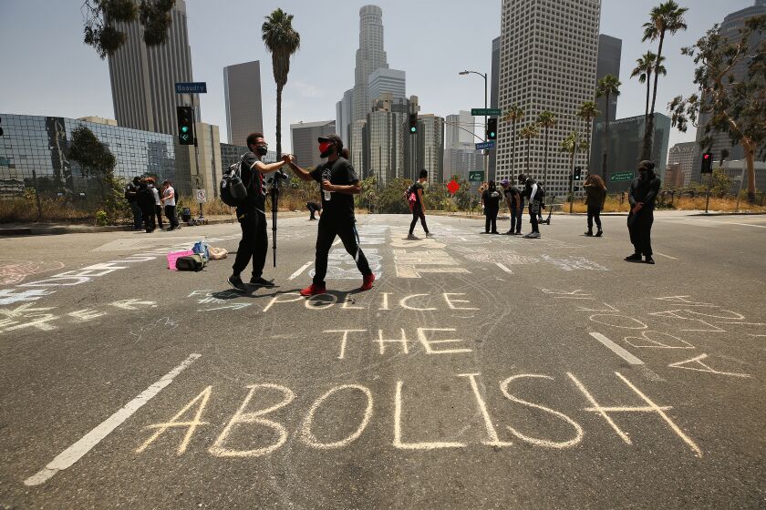 LOS ANGELES, CA - JUNE 23: Protestors painted West 4th Street that was partially shut down as members of Black Lives Matter-Los Angeles and their supporters held a demonstration outside LAUSD headquarters during the School Board Zoom meeting to demand that the Board of Education defund school police, reallocating funds to other student-serving initiatives. Los Angeles on Tuesday, June 23, 2020 in Los Angeles, CA. (Al Seib / Los Angeles Times)