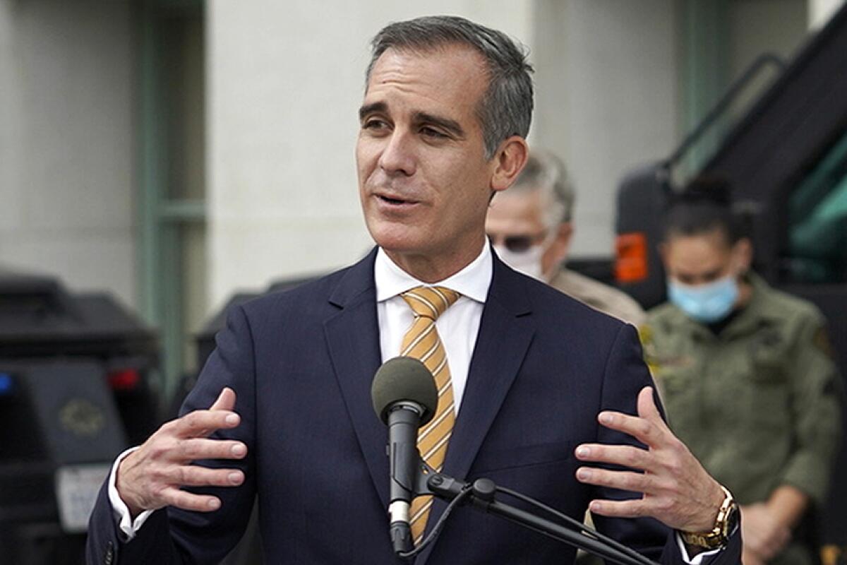 Mayor Eric Garcetti speaks into a microphone