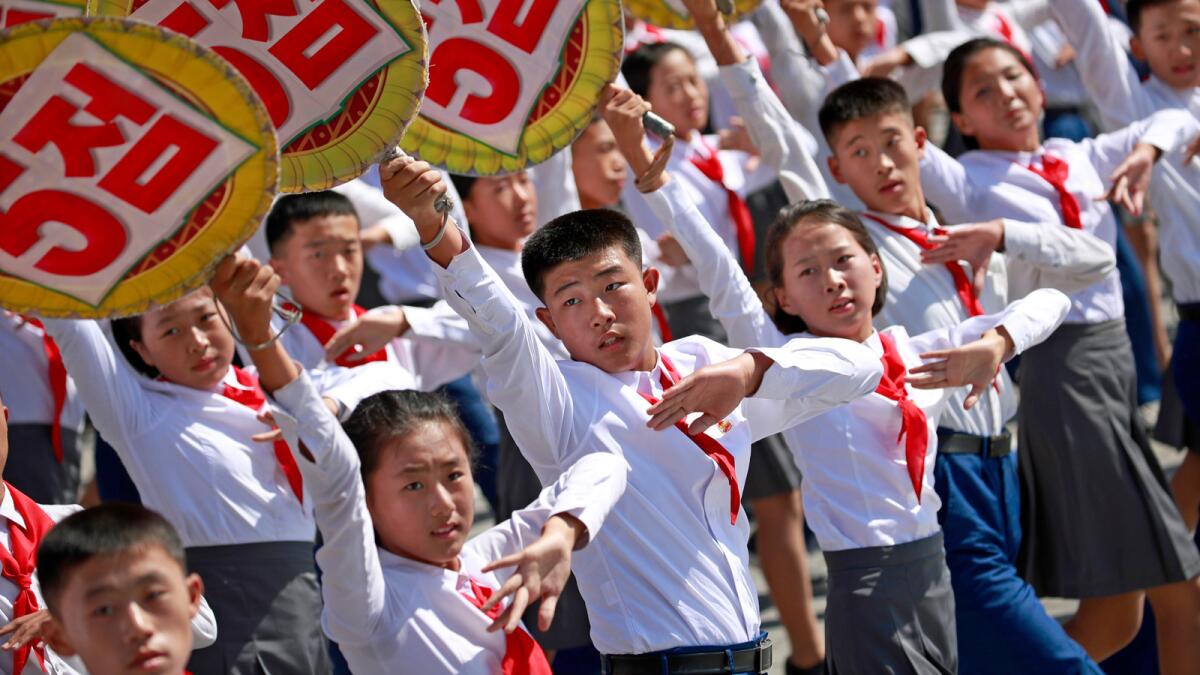 North Korean students perform during the parade.