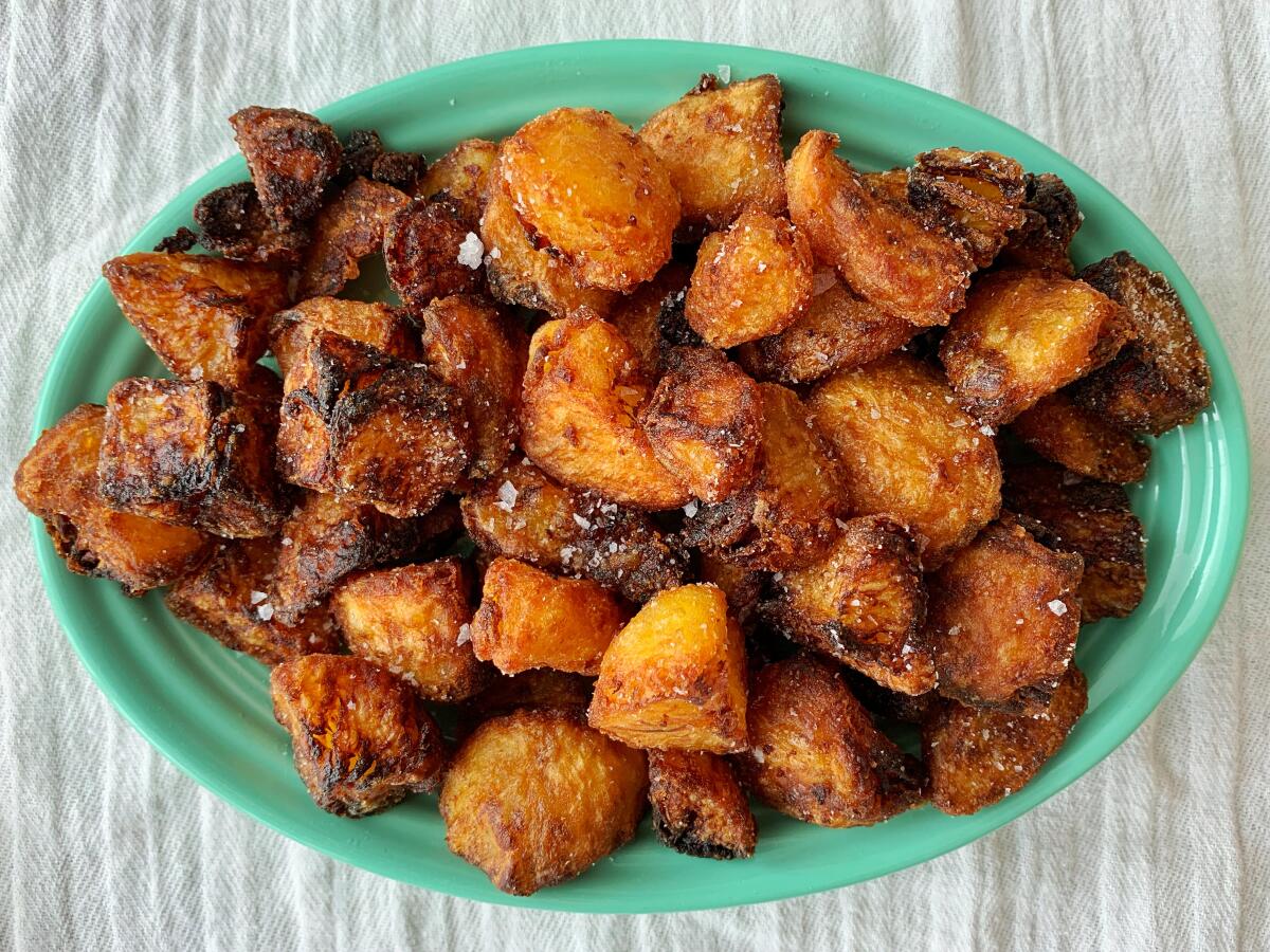 A plate full of English roast potatoes.