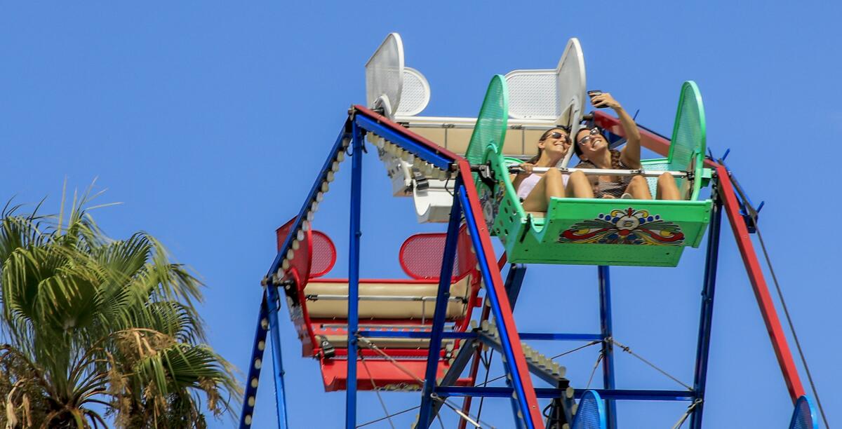 Riders on the Ferris Wheel at the Balboa Fun Zone in Newport Beach. 