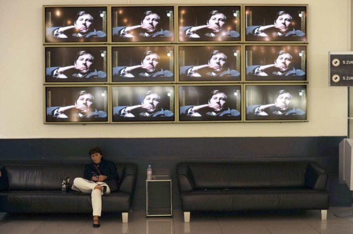 Film director Roman Polanski is shown on a wall of TV screens at the Zurich Film Festival, where he was headed when Swiss officials arrested him at the request of L.A. County prosecutors.