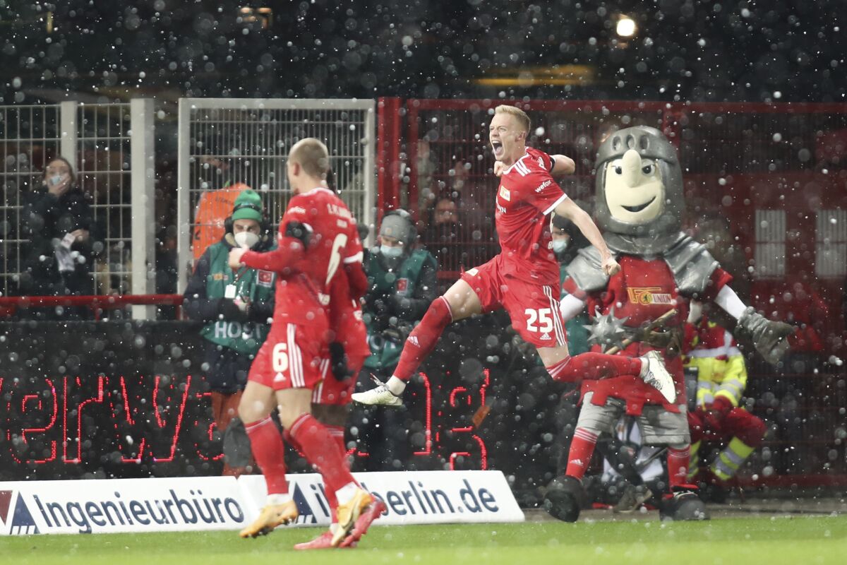 Union's Timo Baumgartl, top right, reacts after scoring his team's second goal during Germany's Bundesliga soccer match between Union Berlin and Leipzig in Berlin, Friday, Dec. 3, 2021. (Andreas Gora/dpa via AP)