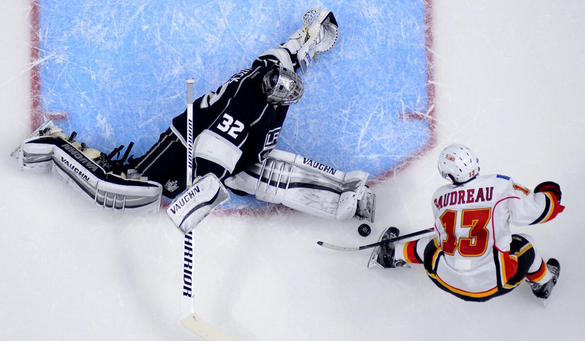 Flames left wing Johnny Gaudreau (13), who had a hat trick, tries to score in overtime on Kings goaltender Jonathan Quick.