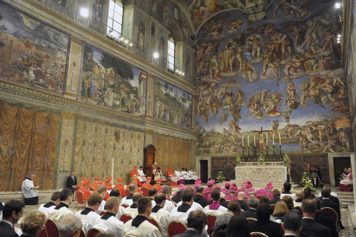 Pope Benedict XVI, seated at left, leads a vesper prayer in the Sistine Chapel in October.