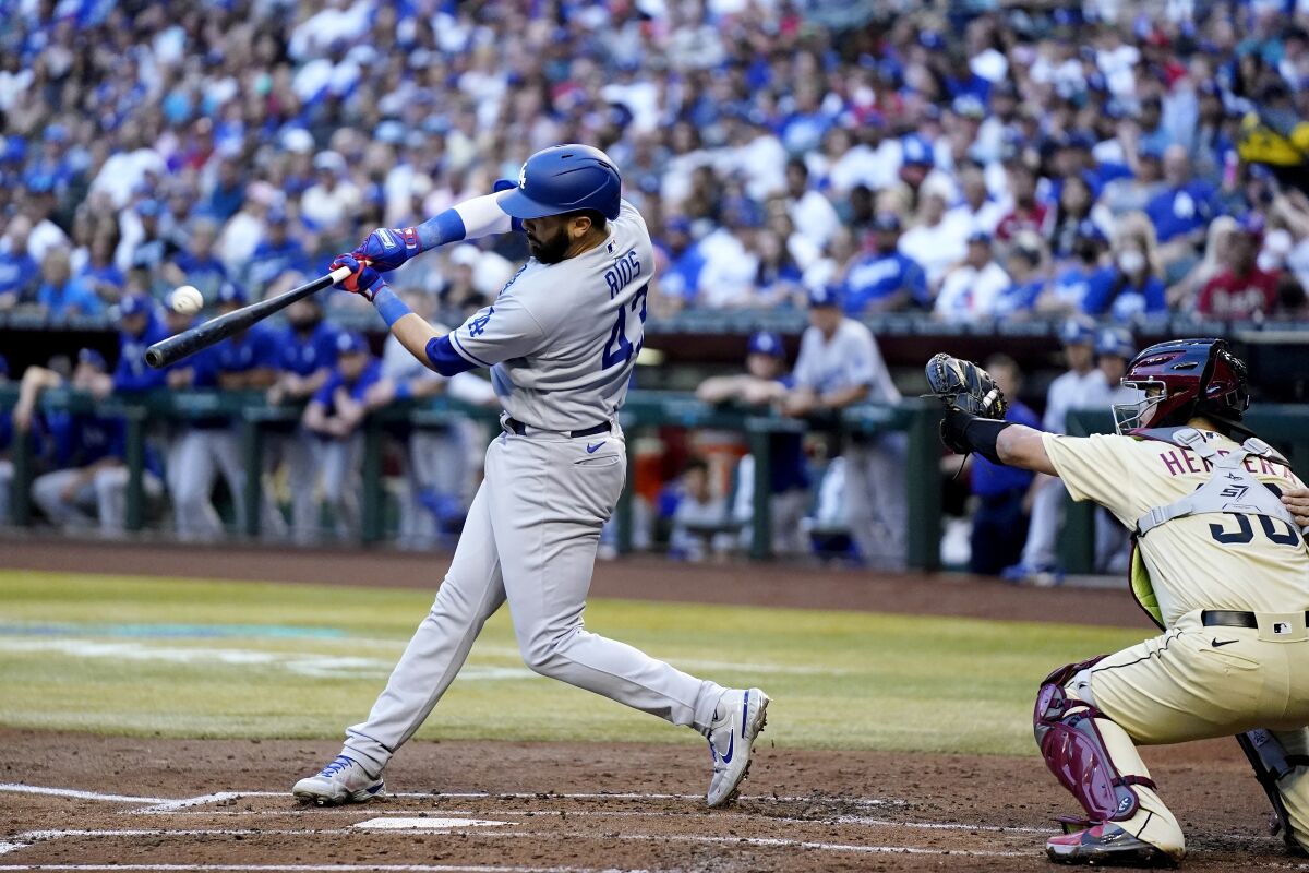 Edwin Ríos connects for a three-run home run in the second inning for the Dodgers against the Diamondbacks.