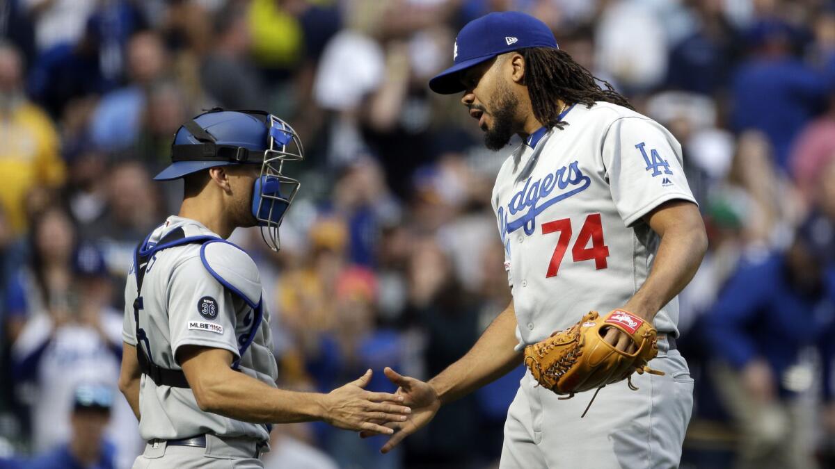 Dodgers closer Kenley Jansen is congratulated by catcher Austin Barnes after a 6-5 win over the Milwaukee Brewers on April 21.