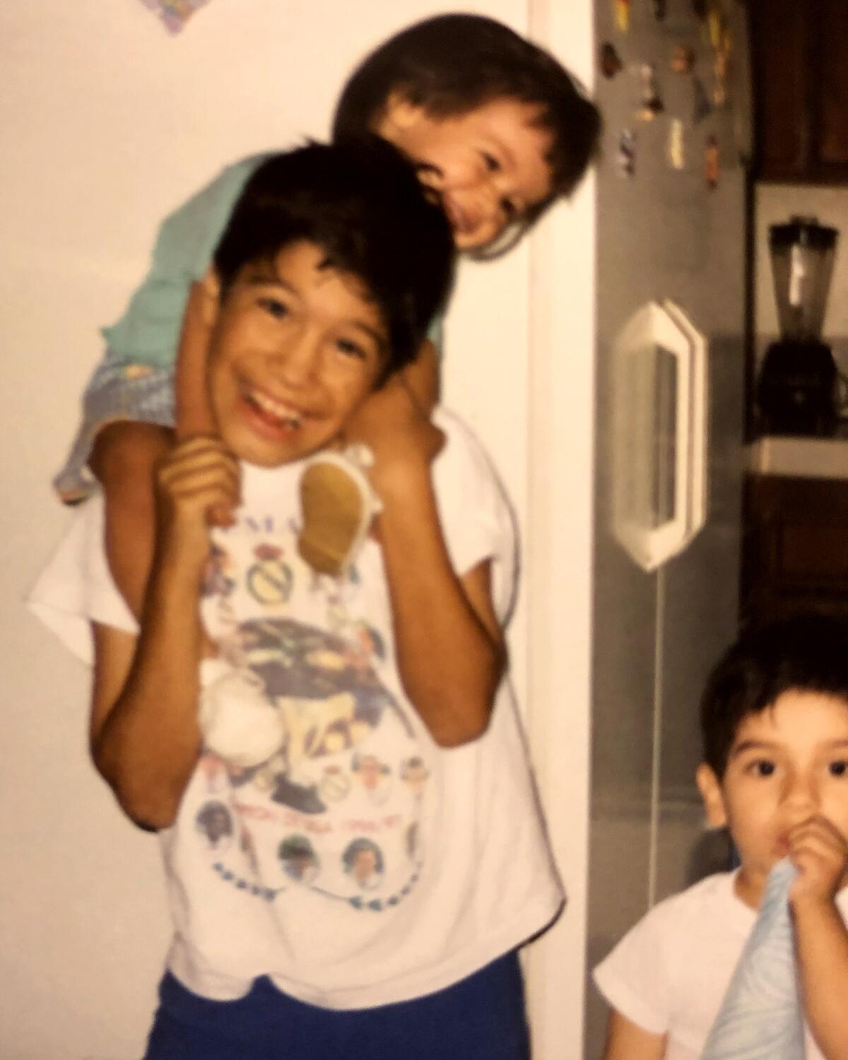 Gabby Fernandez on her brother Ricardo Fernandez's shoulders in 1999.