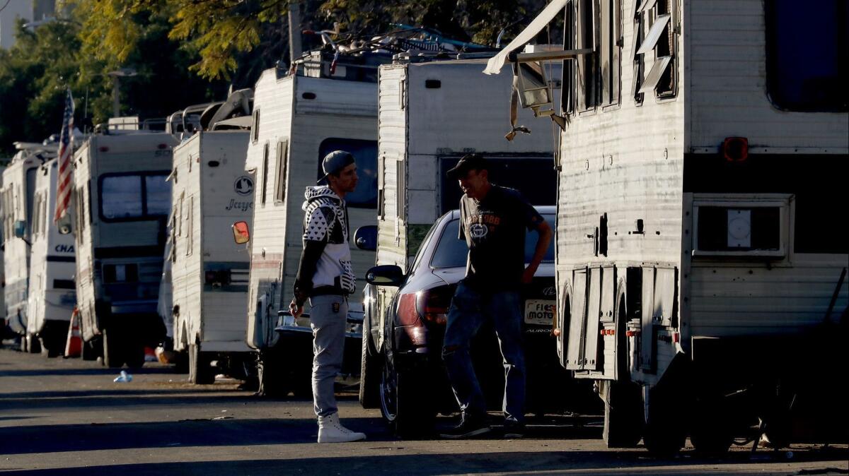 RVs are parked near Los Angeles International Airport. The L.A. City Council opposes a bill to prevent cities from impounding cars with five or more unpaid parking tickets or registration that is six months out of date.