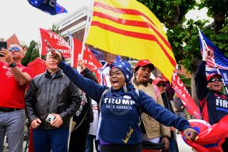 Supporters hold flags as they rally in anticipation of former President Donald Trump's arrival at a fundraising event in San Francisco, California, on June 6, 2024. (Photo by JOSH EDELSON / AFP)