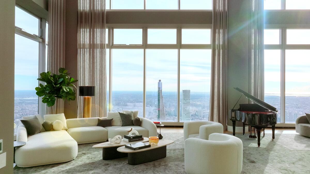 The interior of a Manhattan home that showcases floor-to-ceiling windows. 