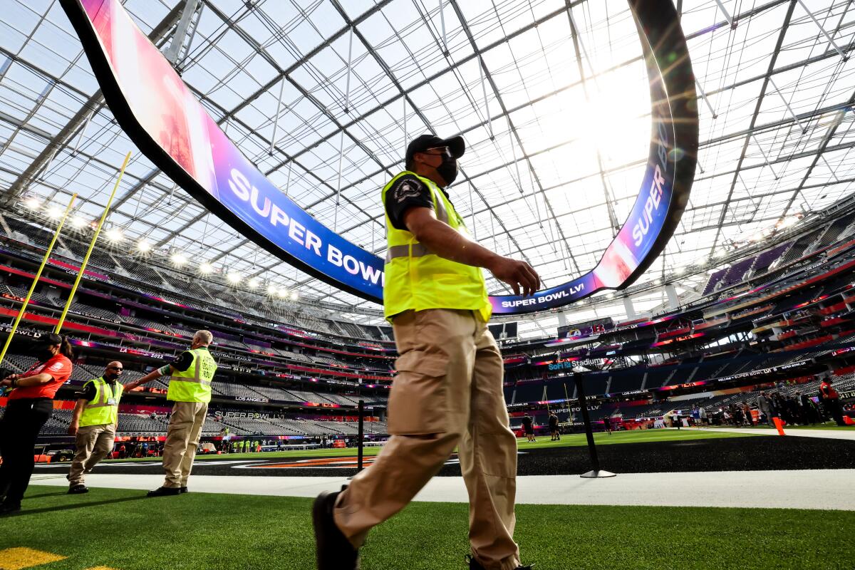 Security walks on the field before the start of Super Bowl LVI at SoFi Stadium.