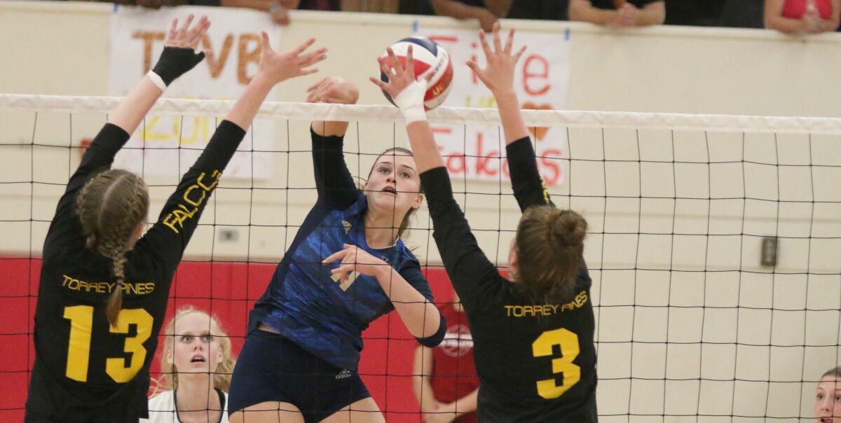 LCC middle blocker Taylor Putnam looks for a hole in the Torrey Pines block.
