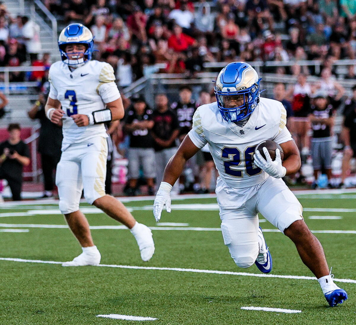 Santa Margarita High's 5-foot-4 running back Adrian Petero runs to his left with quarterback Fletch Palmer in the background.