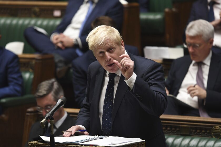 In this handout photo provided by UK Parliament, Britain's Prime Minister Boris Johnson speaks in the House of Commons, London, Tuesday, Sept. 7, 2021. Johnson told lawmakers in the House of Commons that he had made the “difficult but responsible” decision to hike taxes in order to raise 36 billion pounds ($50 billion) over three years for social care and the overstretched National Health Service. (Jessica Taylor/UK Parliament via AP)