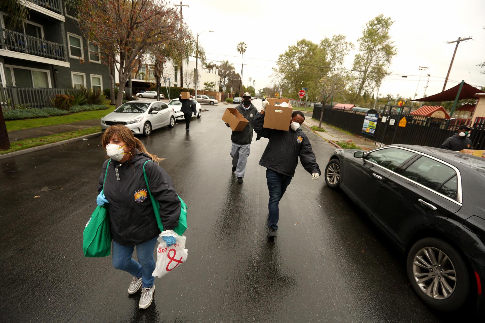 Claudia Bracho, left, and other intervention workers deliver groceries.