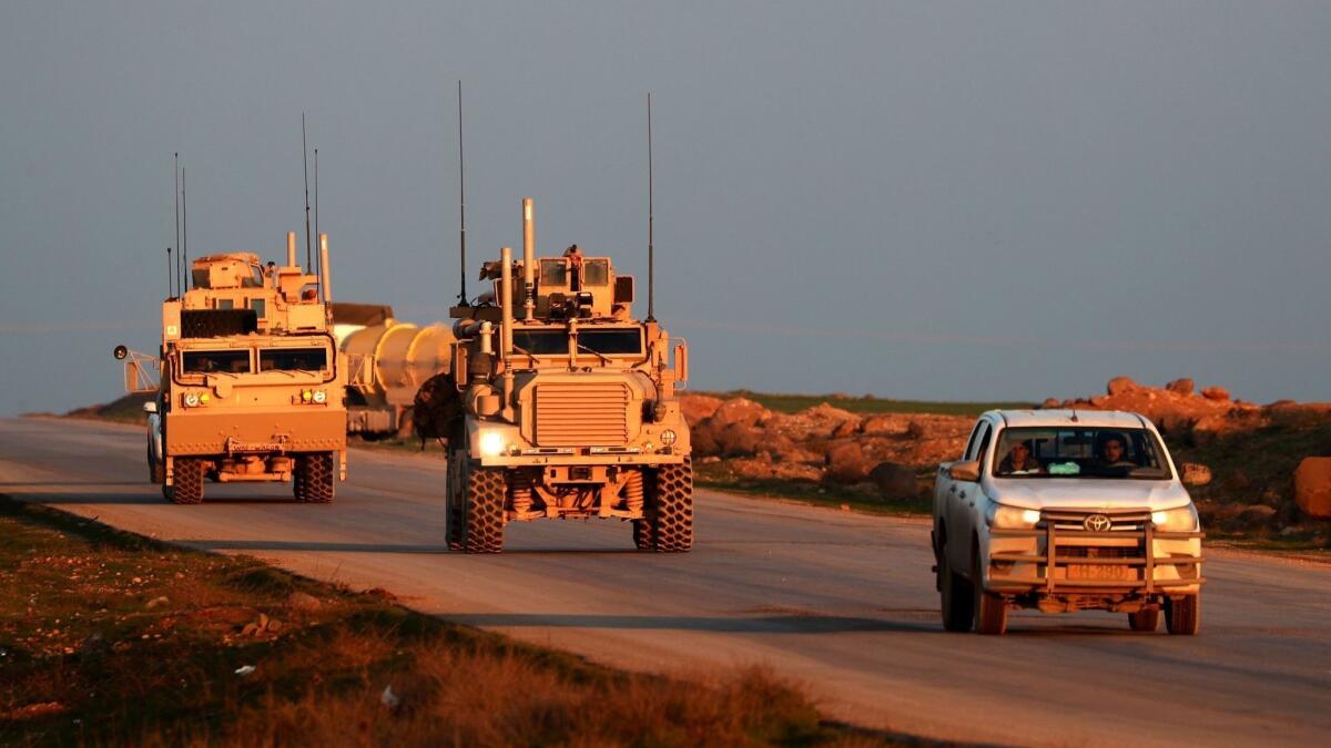 U.S. Marine Corps vehicles are escorted by a Syrian Democratic Forces pickup truck near the town of Tal Baydar in northeastern Syria's Hasakah province on Dec. 21, 2018.